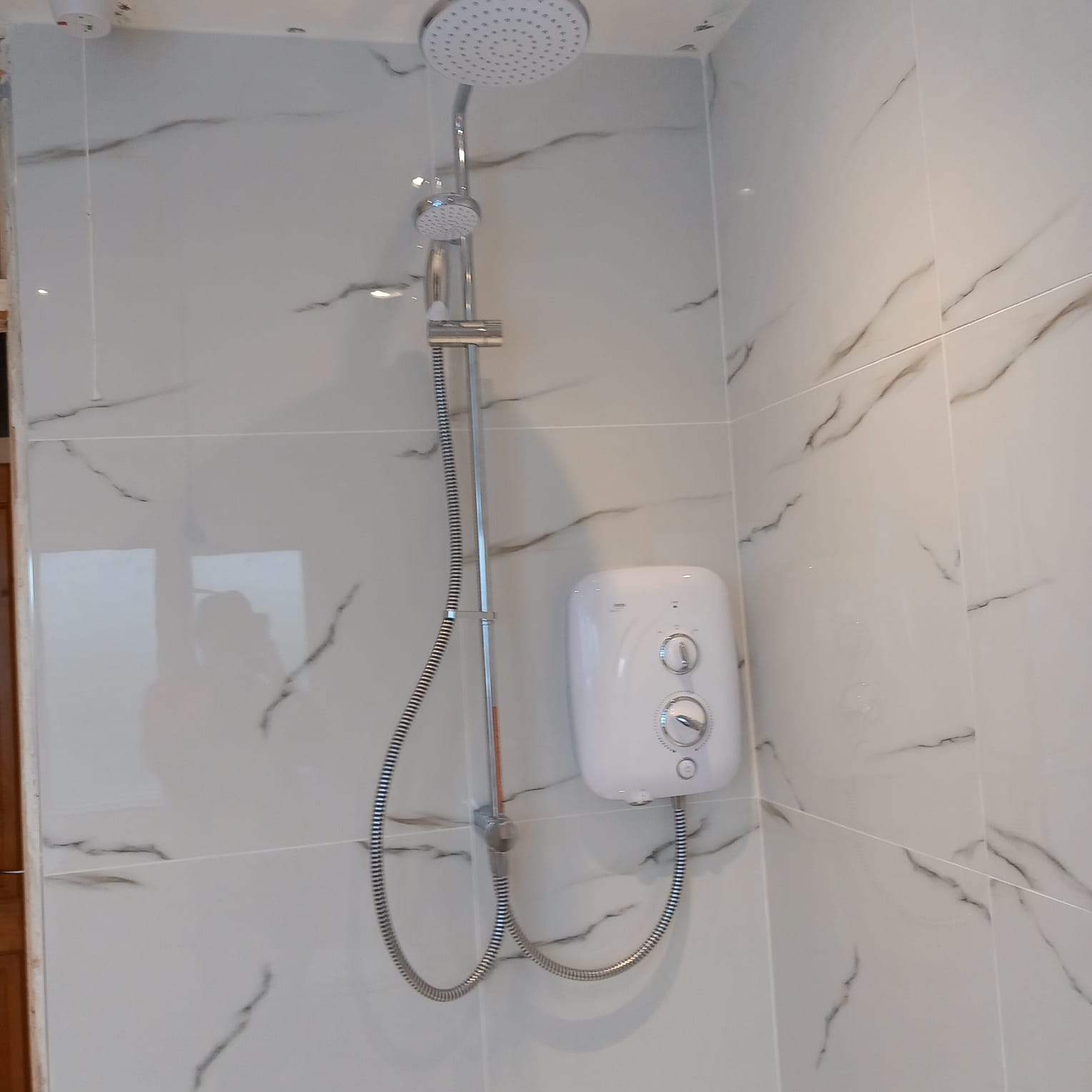 Electric shower on marble tiling