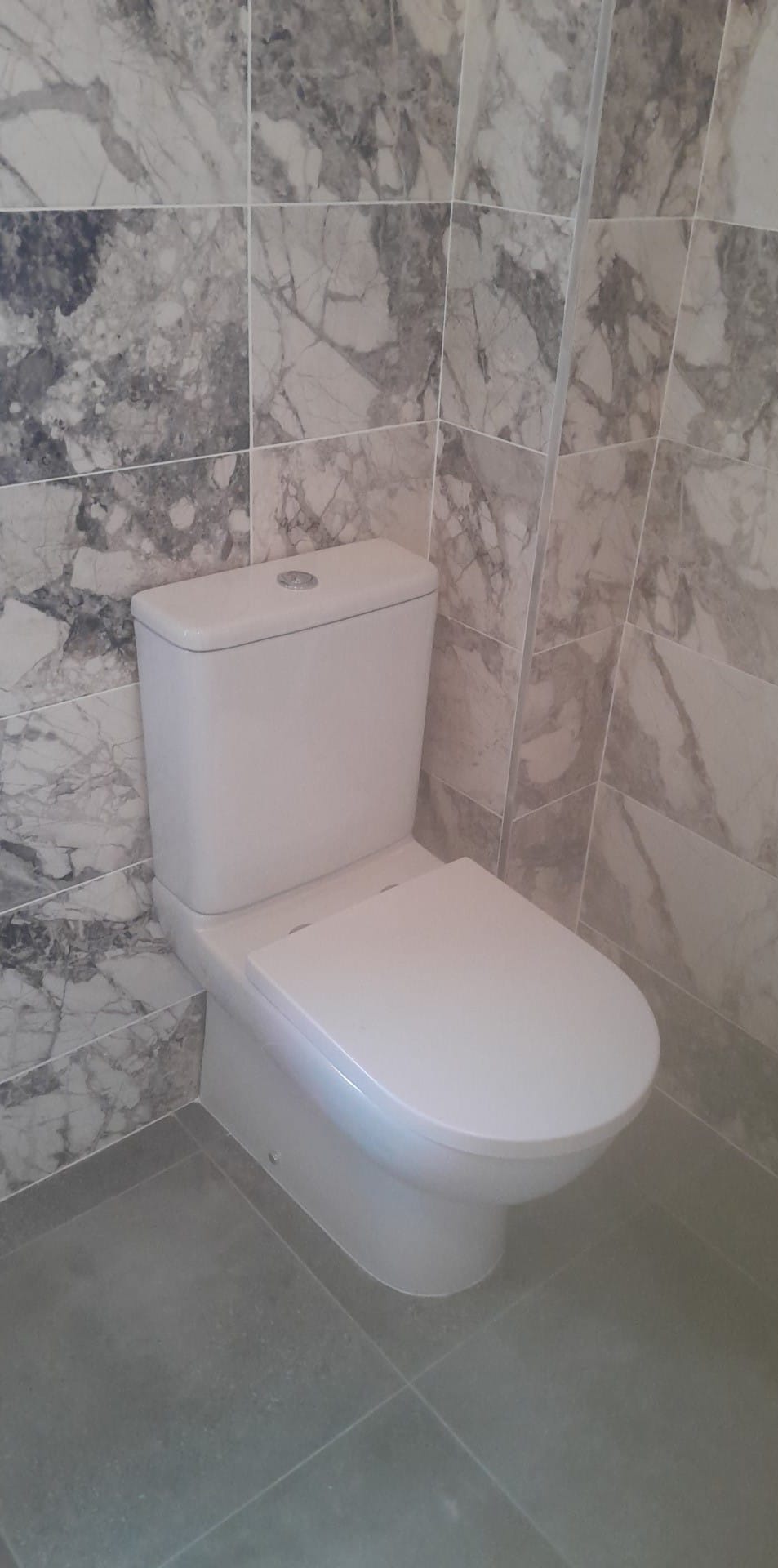 WC in a marble-tiled bathroom