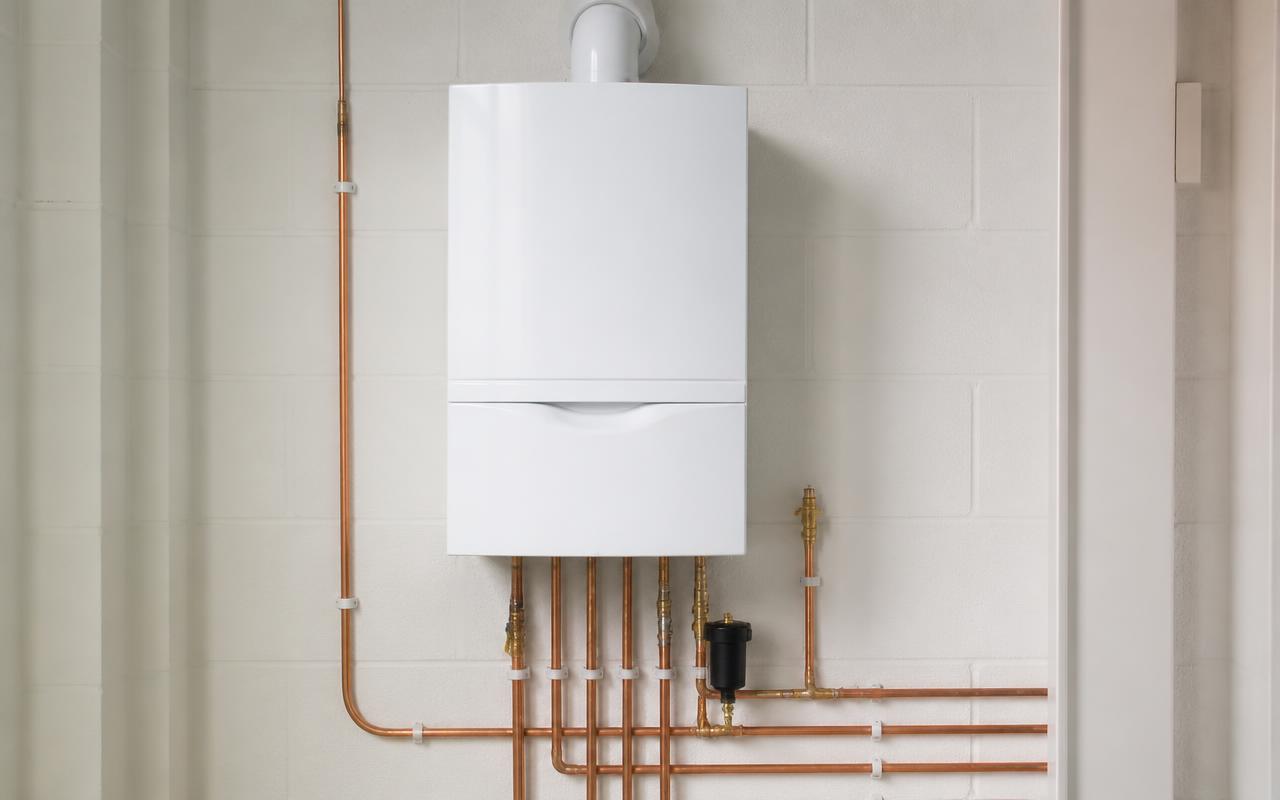 Newly installed white gas boiler with neat copper pipework